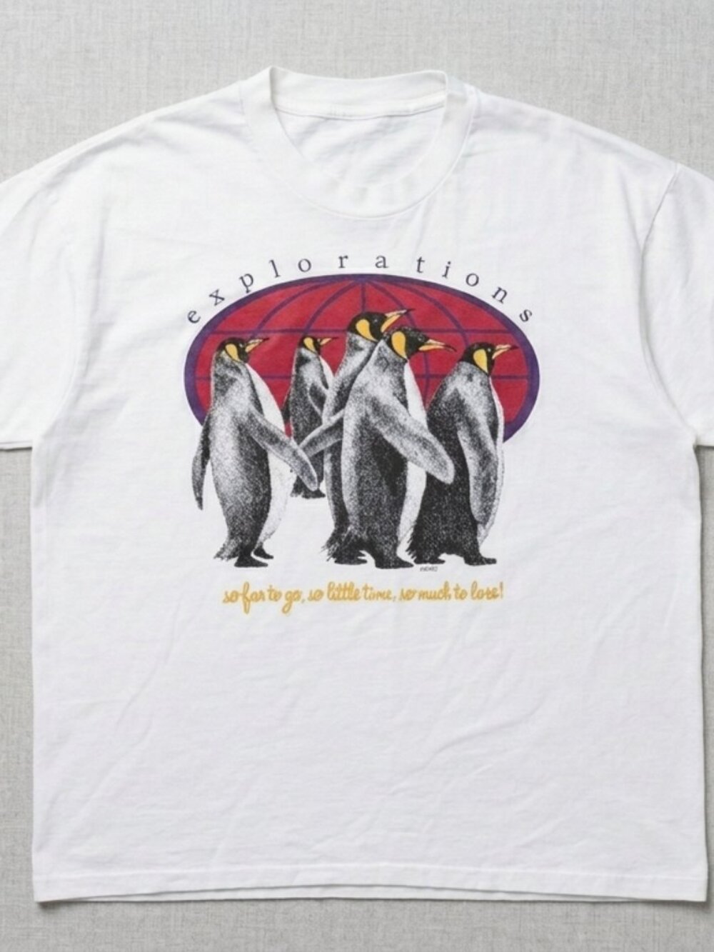 T-shirt features a graphic of emperor penguins